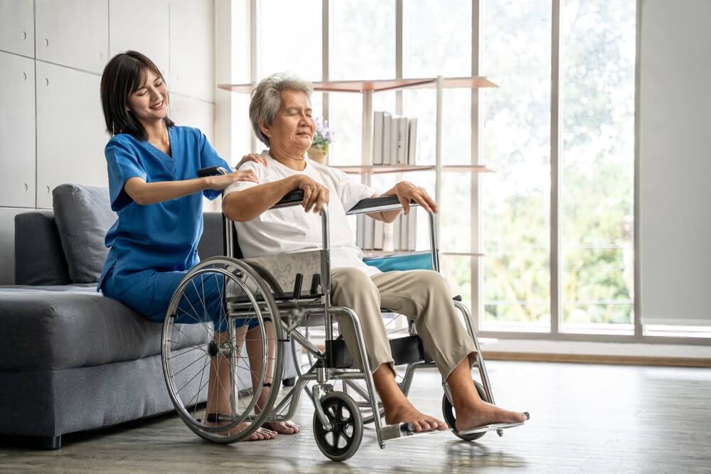 Beautiful asian nurse taking care of senior woman to exercise at hospital. She feeling happy when take care senior woman