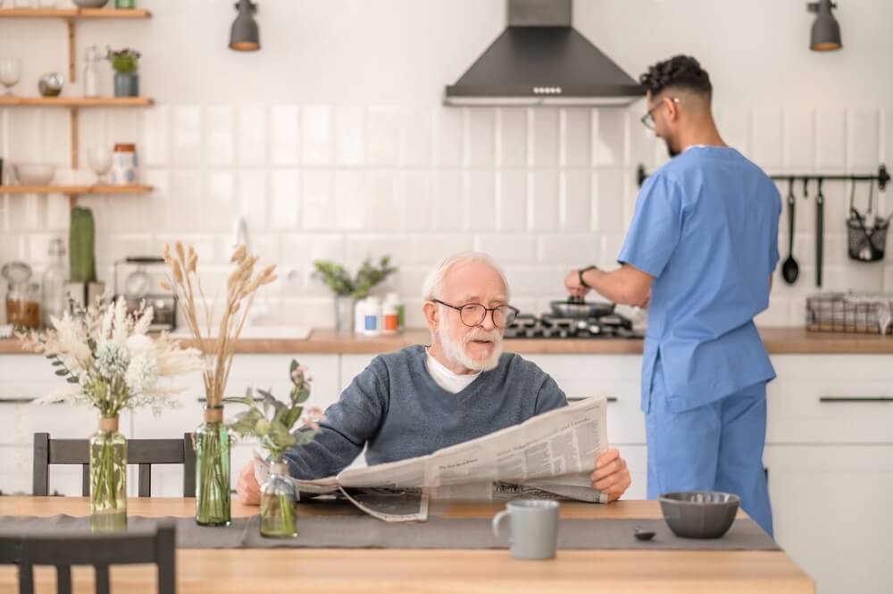 Elderly person waiting for his breakfast at the table